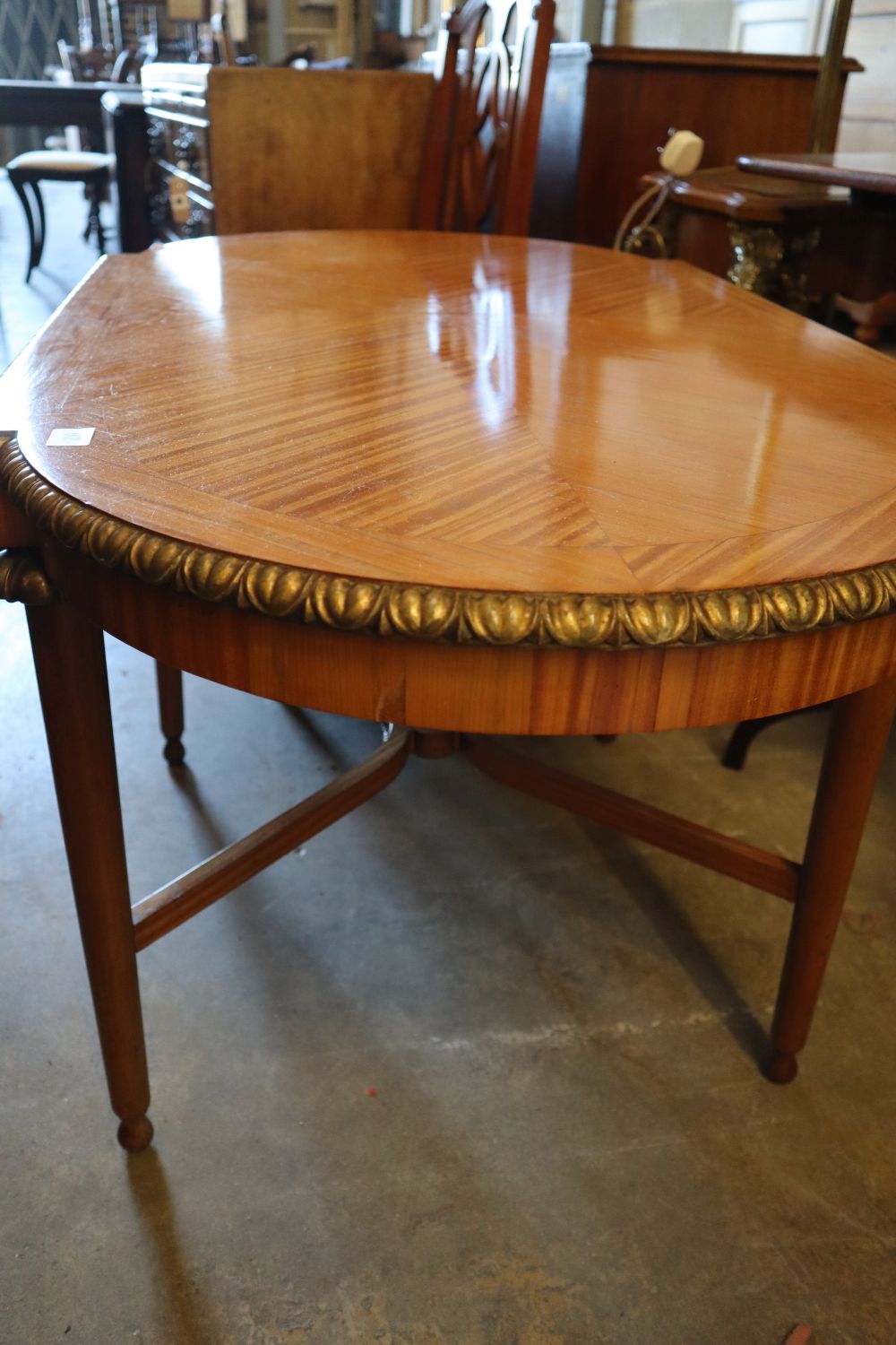 A parcel gilt satinwood centre table, width 113cm height 62cm, and a pair of Edwardian satinwood salon chairs